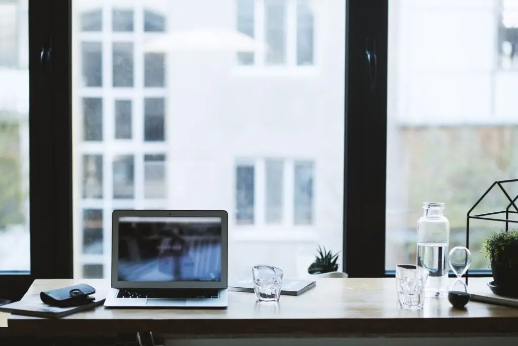Laptop open on a home office desk used to manage vacation rental listings across booking channels