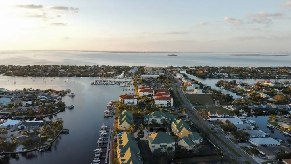 Aerial view of a Southwest Florida waterfront canal community and marina at sunset