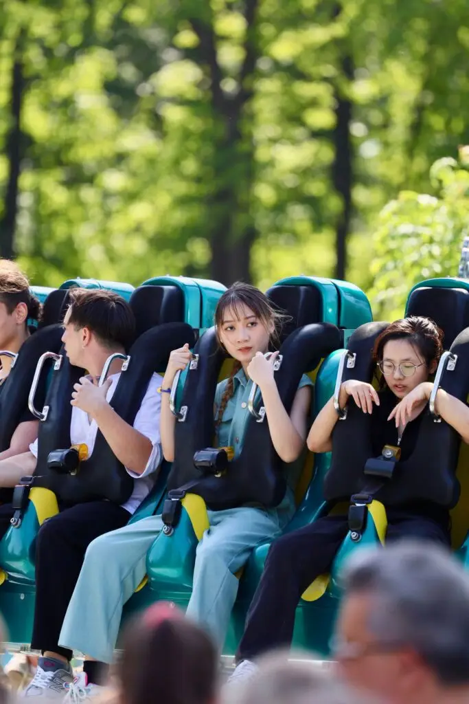 Roller coaster track curving against a bright sky at a theme park