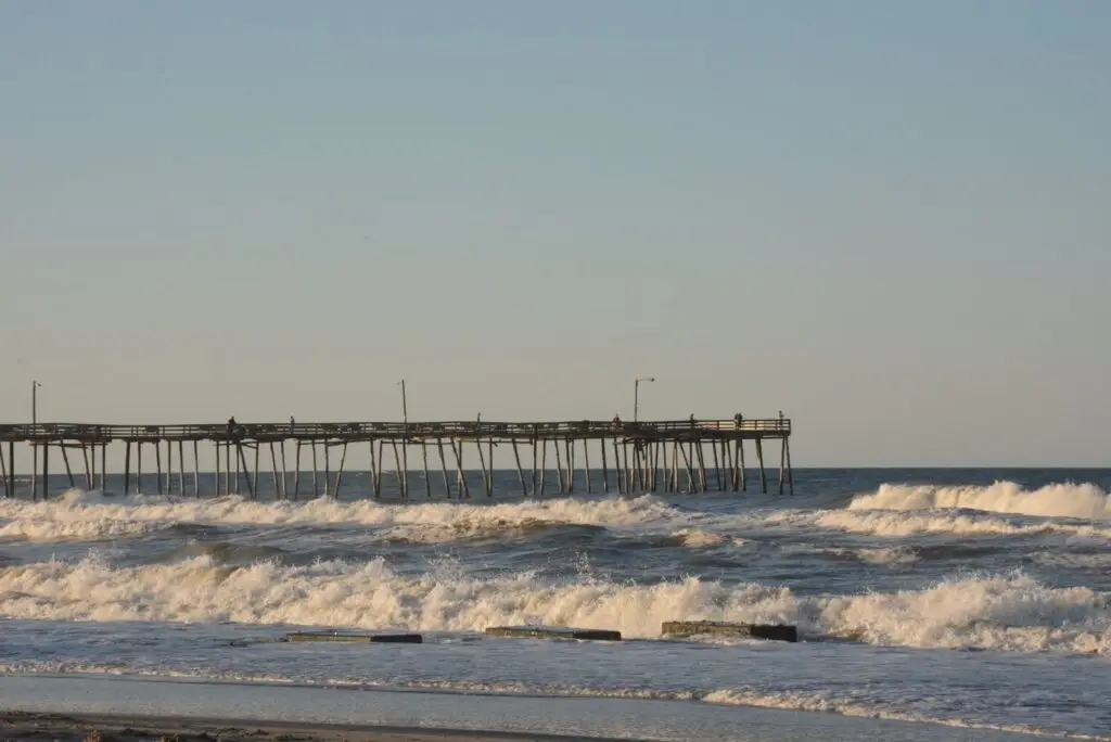 Wooden fishing pier reaching over the Gulf of Mexico at sunset